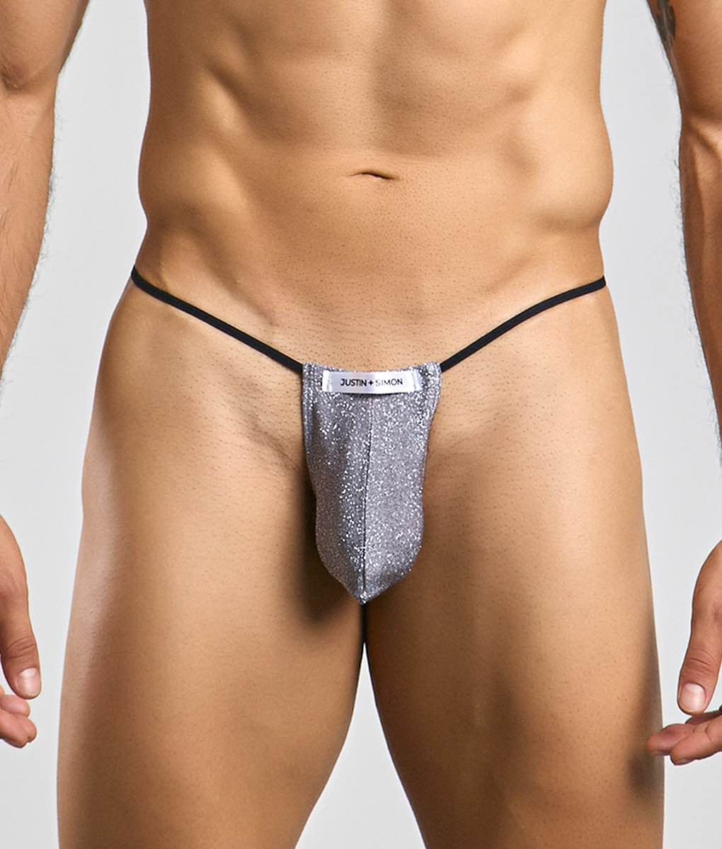 Silver glittery thong with black elastic waistband and justin simon label from the justin simon classic g-string bulge collection