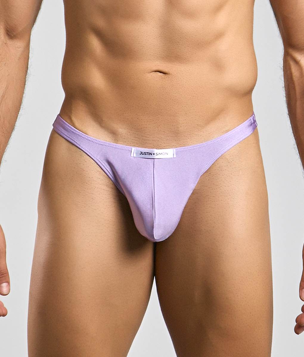 Lavender-colored form-fitting thong made of soft fabric by justin simon shown from the back in the classic tanga style