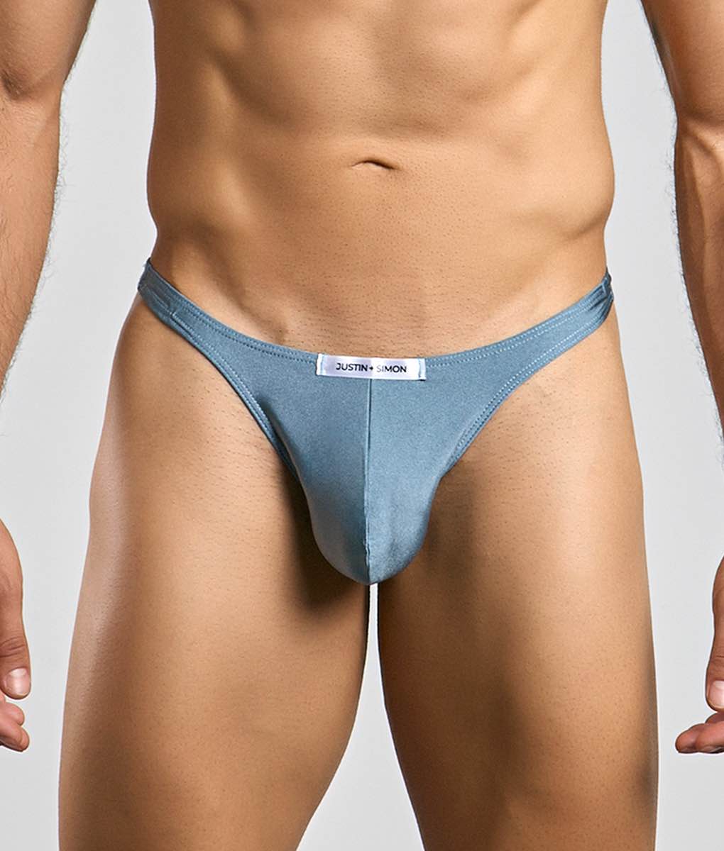 A light blue form-fitting thong with a justin simon label at the waistband from the Justin plus Simon Classic Tanga line