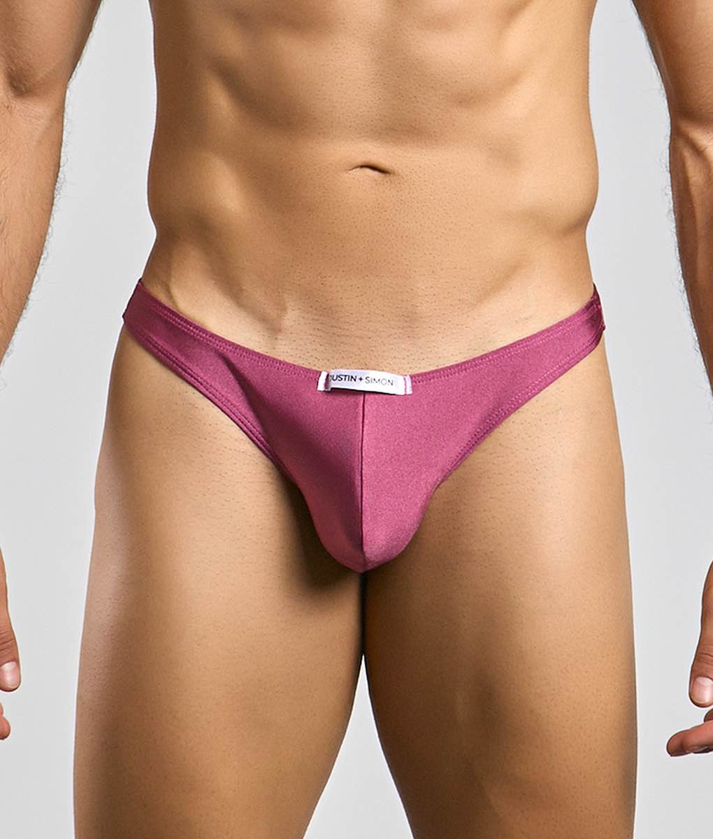 A sleek magenta classic tanga thong by Justin plus Simon made of smooth fabric with a minimalist design and white label