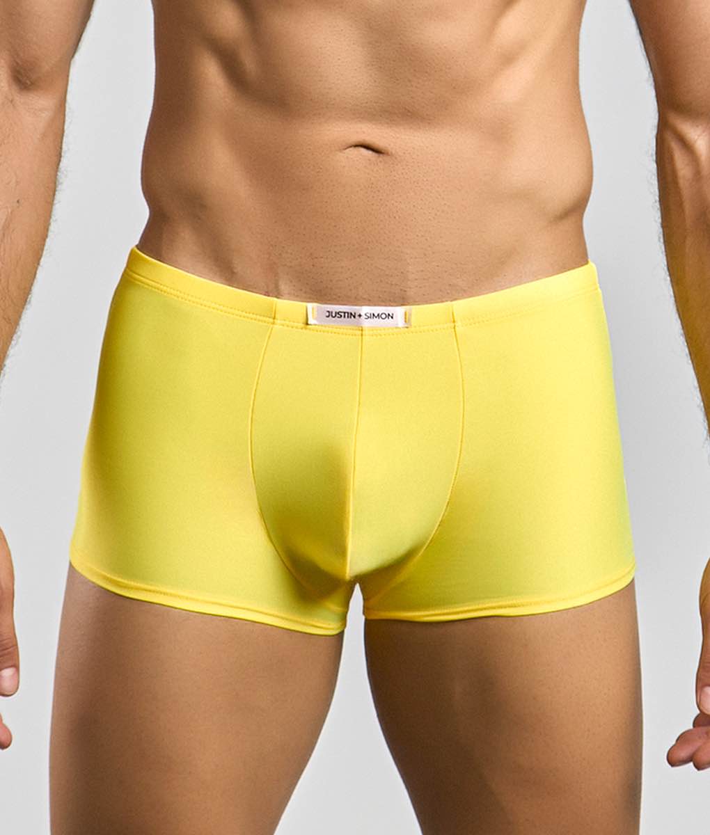 Bright yellow justin simon classic boxer men’s briefs in smooth form fitting fabric with white brand tag at waistband