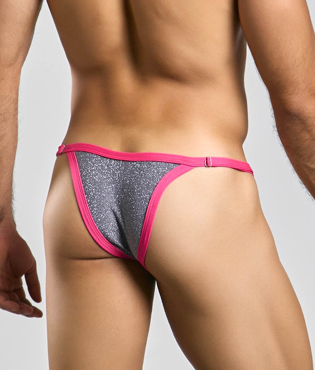 A vibrant pink and silver glitter thong from the justin plus simon bikini one collection with a snug fit
