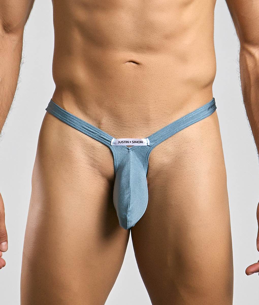 Blue denim-style bulge thong with central pouch and justin + simon branding on waistband by justin + simon