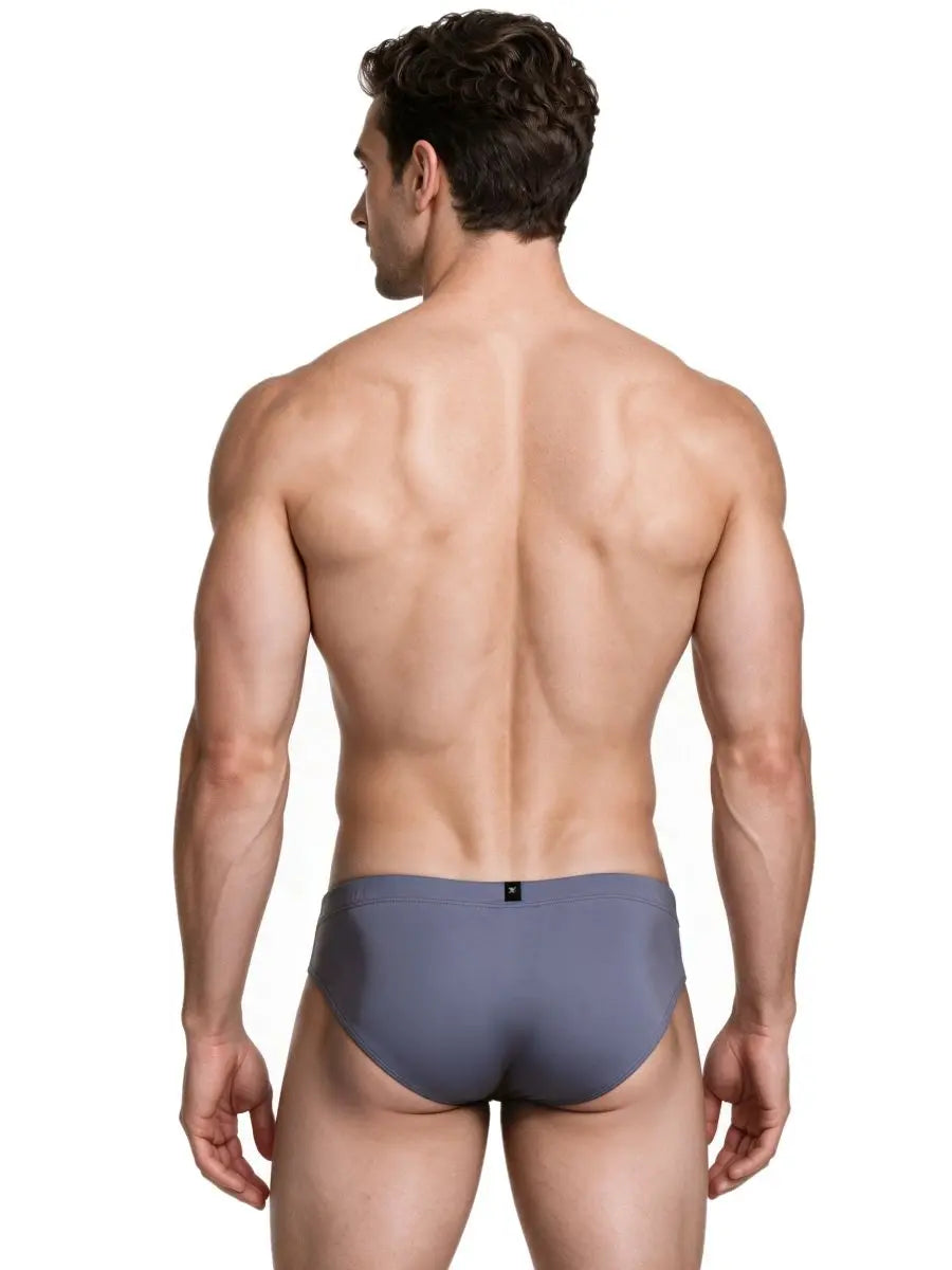 Rear view of a man wearing gray sleek microfiber briefs with a small black logo tag on the waistband by Xtremen