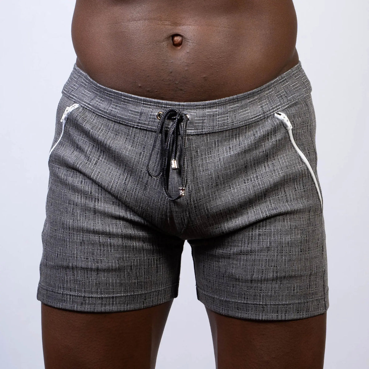 Abstract linen texture shorts in gray with textured fabric, white zipper accents, and black drawstring waistband