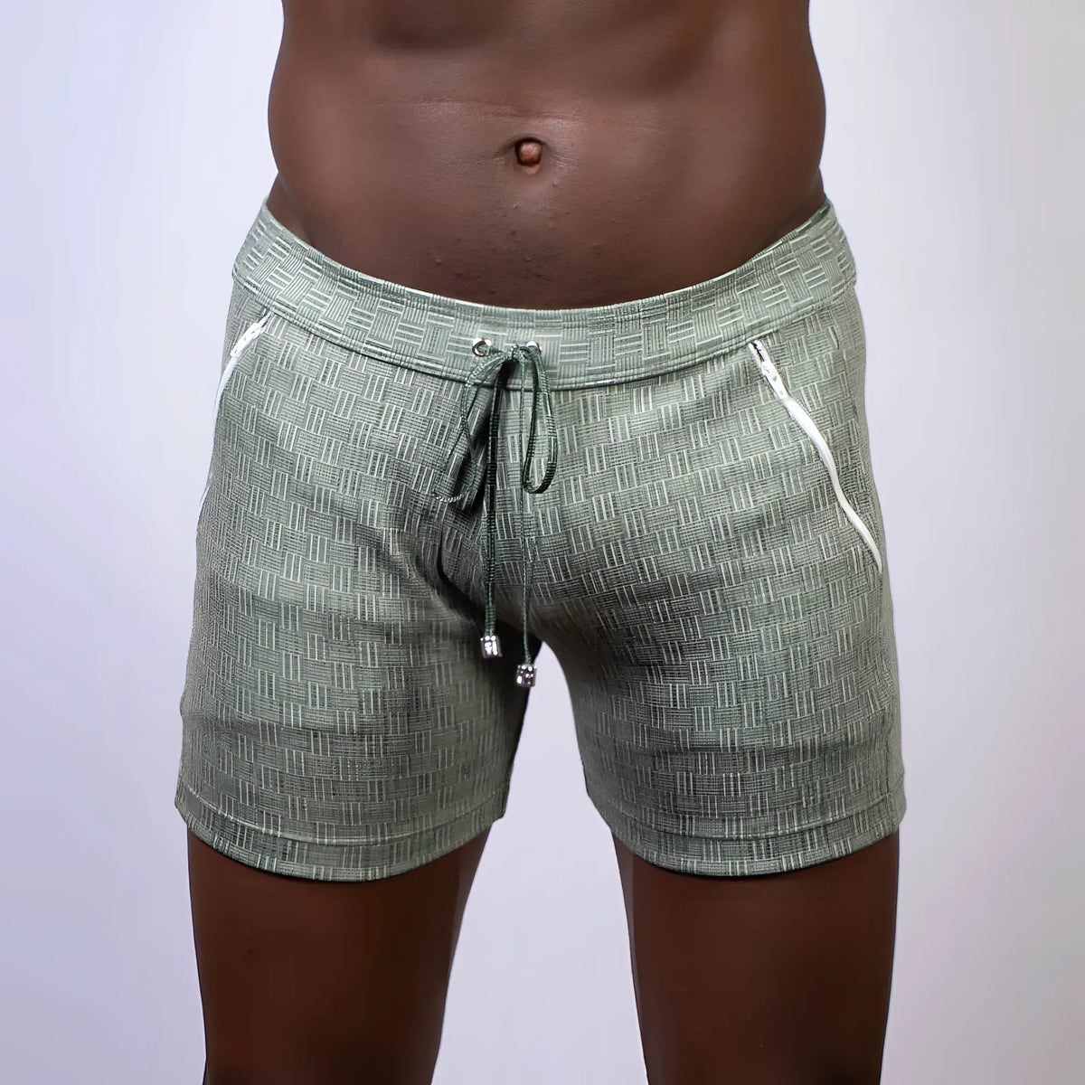 Olive green abstract linen texture shorts with white zipper accents and a drawstring waistband for casual wear