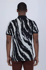 Abstract polo shirt in black and white zebra stripe with a textured woven pattern