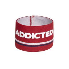 Red elastic wristband bracelet with bold white addicted lettering and navy stripe on textured fabric, size one size