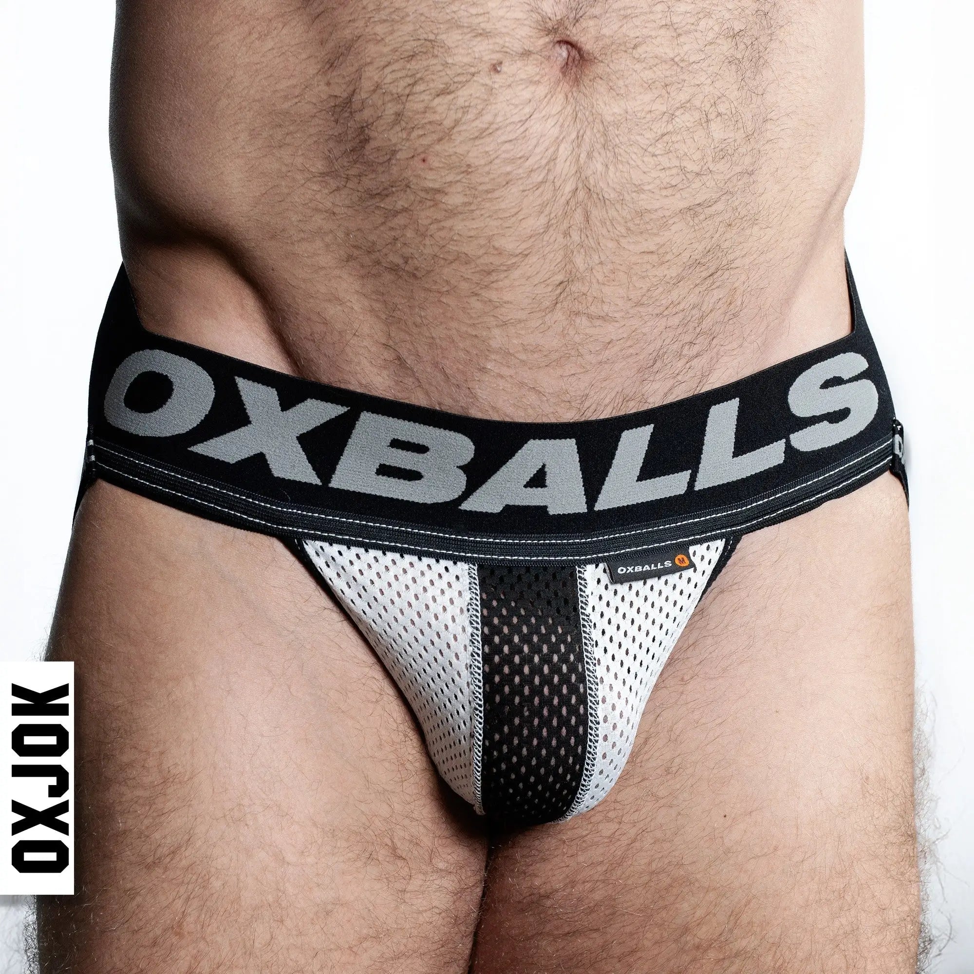 Black and white airmesh jockstrap briefs with breathable mesh fabric and bold oxballs logo waistband visible from front