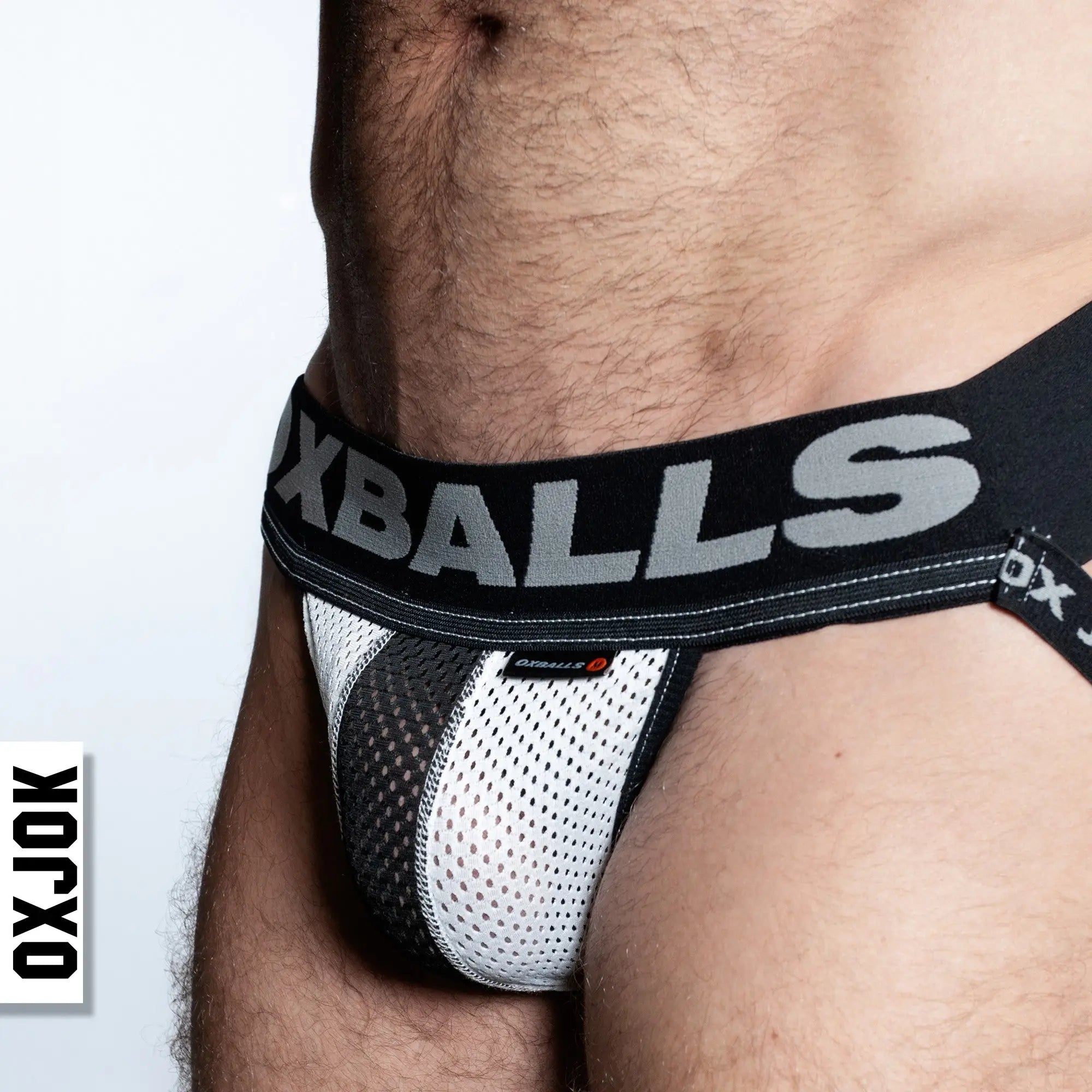 Black and white airmesh jockstrap briefs with bold oxballs logo on the waistband in breathable mesh material