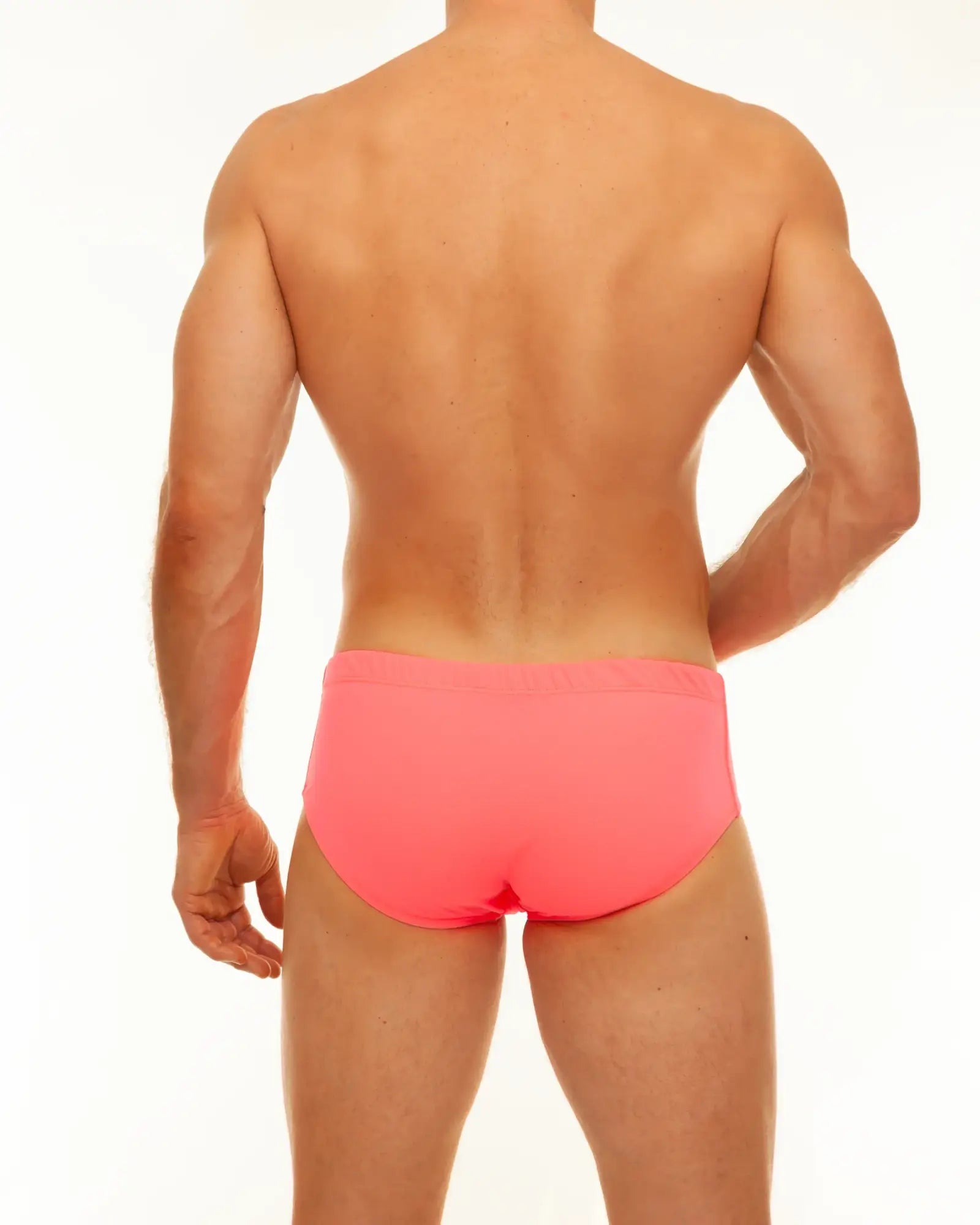 Bright pink swim brief made of solid material designed for swimming and beach use