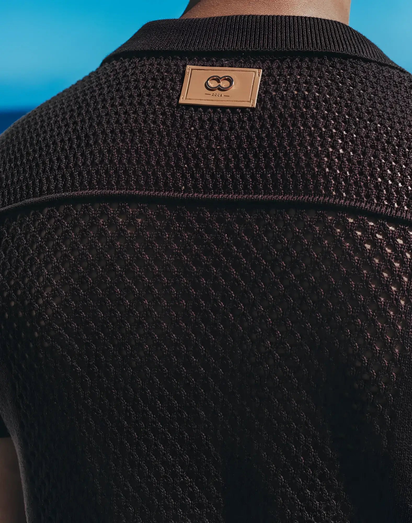 Black textured knit polo shirt with tan leather patch and interlocking double o logo amafi knit shirt