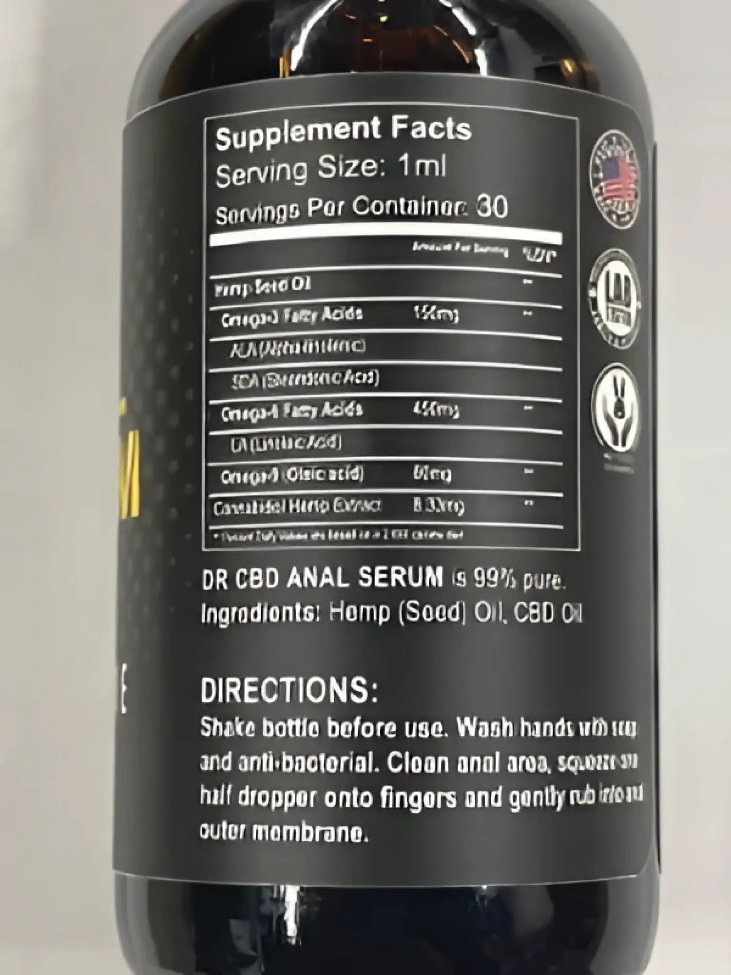 Dark amber glass bottle of dr cbd anal serum with black label and 95 percent pure hemp seed oil and american flag emblem