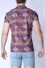 A man wearing a balboa button down shirt with a colorful mandala pattern in purple pink and green on maroon fabric