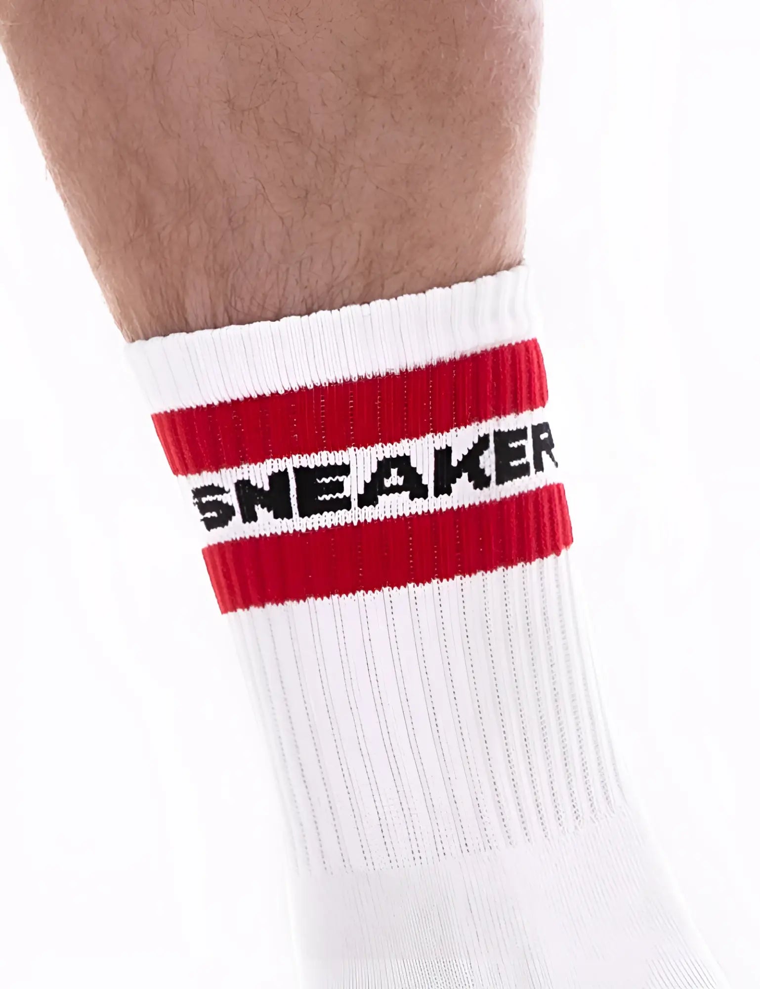 White athletic sneaker half sock by barcode berlin with bold red stripe and black lettering on the cuff size s/m