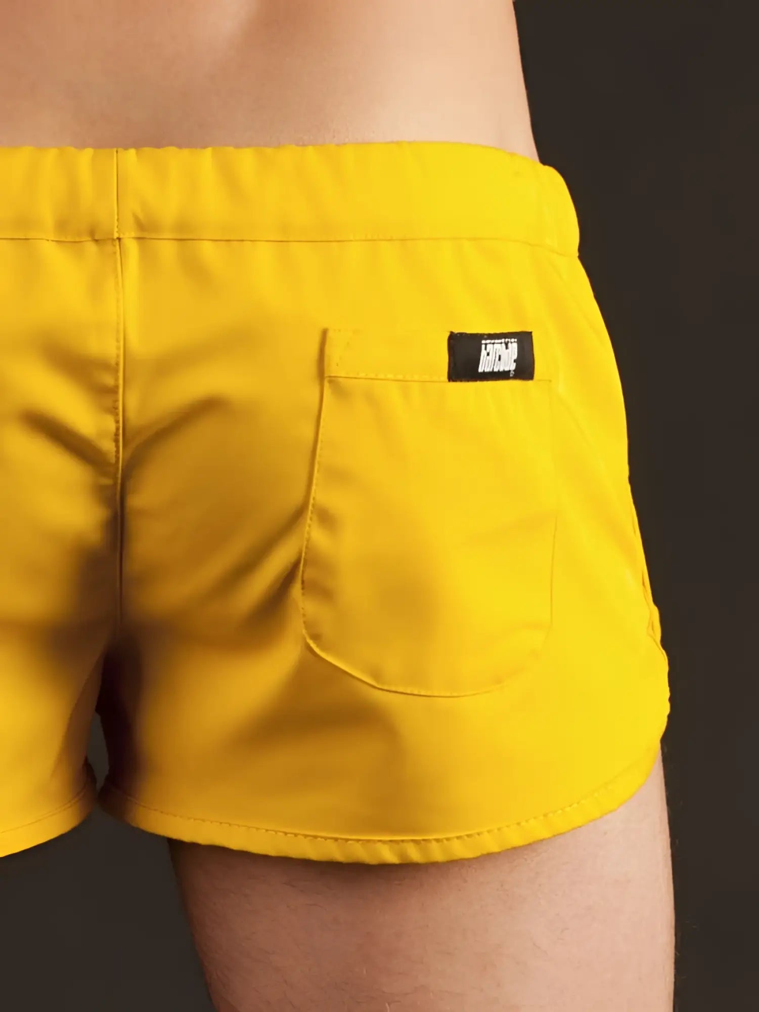 Bright yellow barcode berlin gym shorts xl showing back side with black brand patch on back pocket