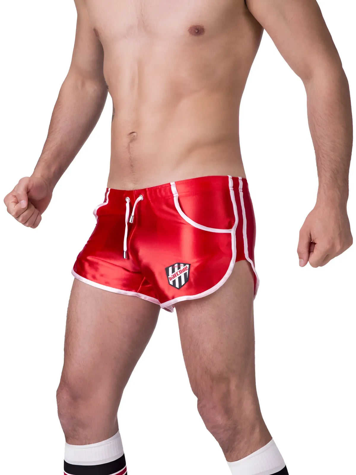 Red satin athletic shorts with white trim and a black and white shield logo on the left leg size xl by barcode berlin