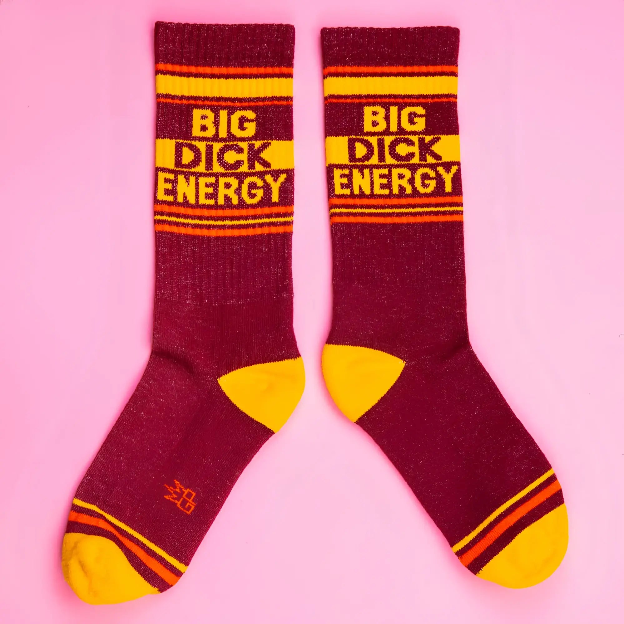 Big dick energy crew socks in maroon and yellow stripes featuring bold text and textured knit material