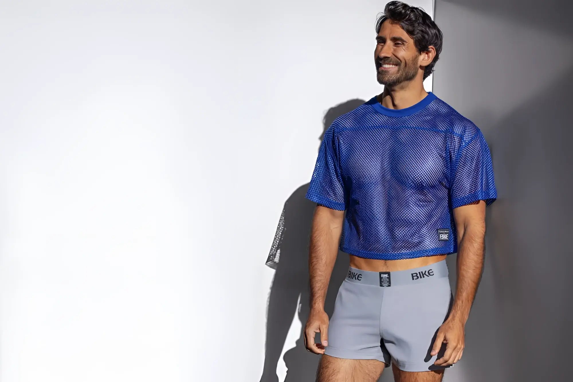 Blue mesh crop top with subtle texture and a small black logo on lower left side in royal BAM134 practice jersey