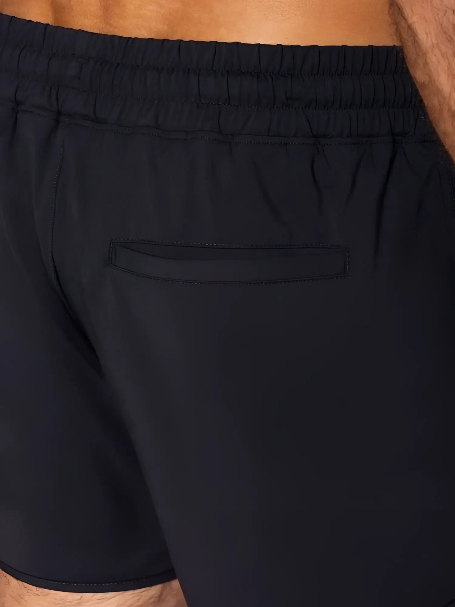 Black bike athletic bam200 track shorts shown from the back with elastic waistband and single back pocket