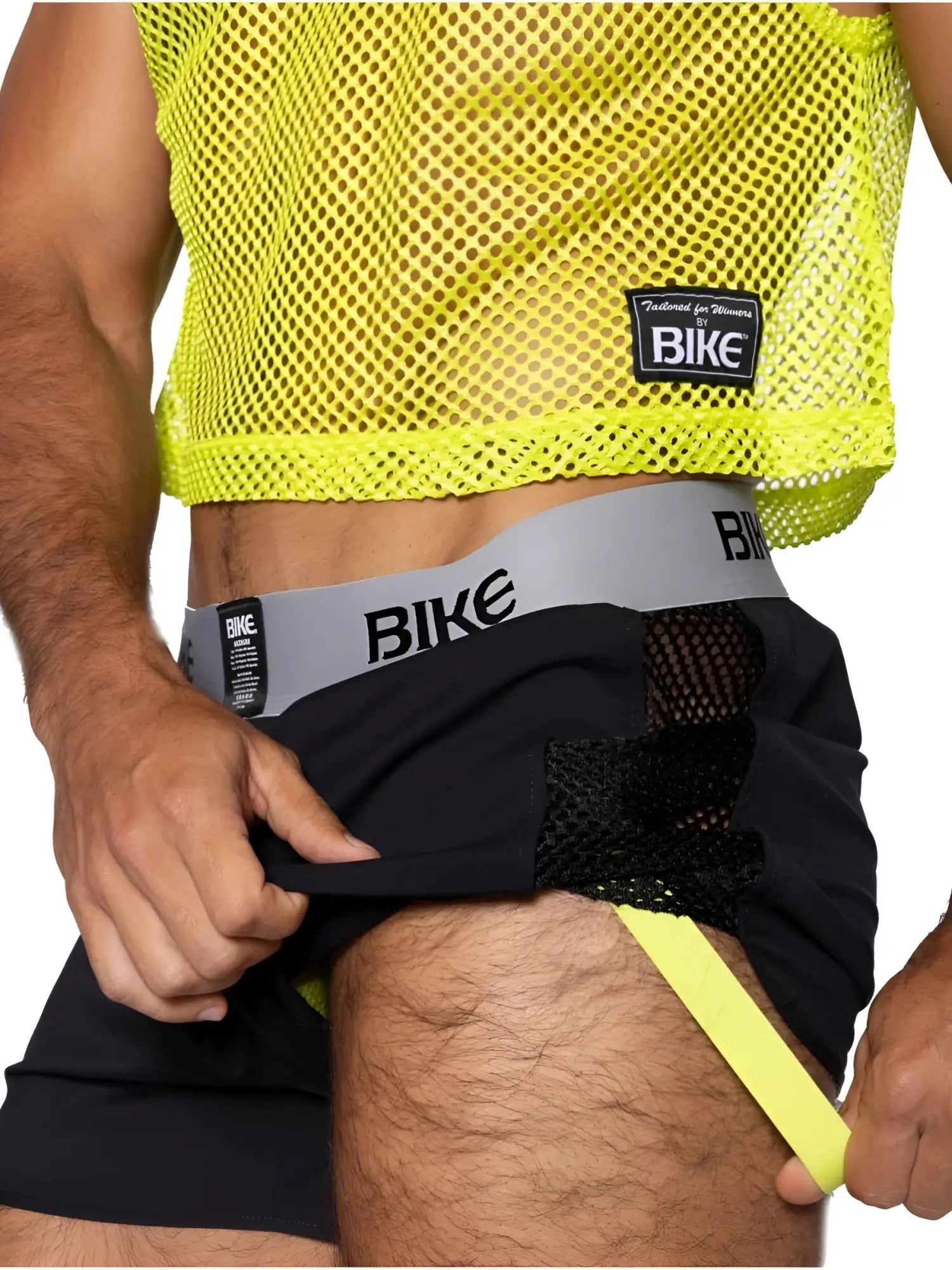 Bright neon yellow mesh crop top with black fabric accents and bike branded waistband for athletic use