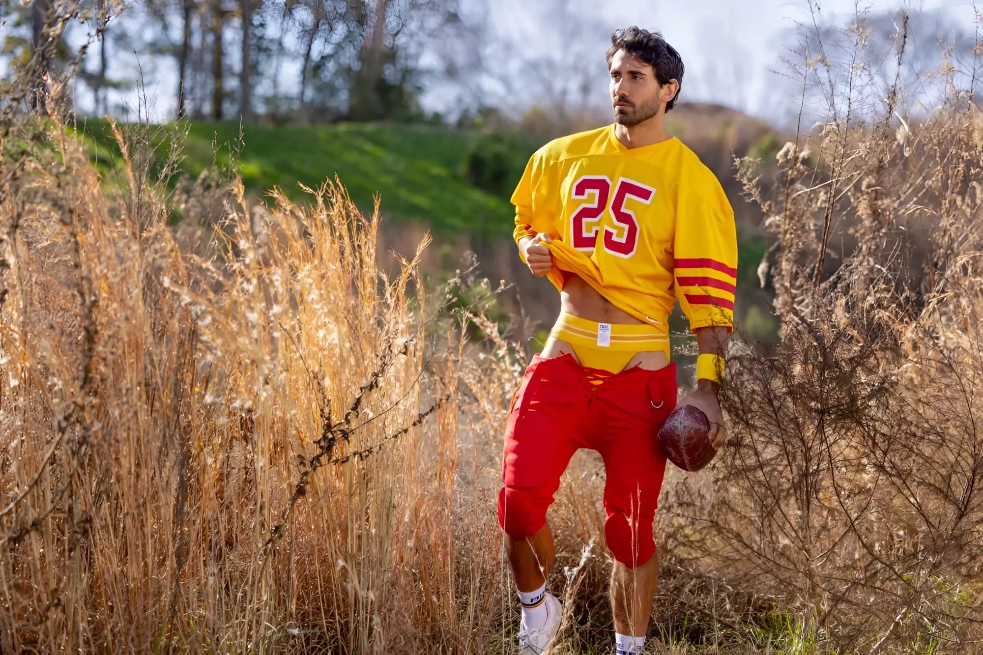 Yellow football jersey with red number 25 and stripes worn over red pants in BIKE Athletic BAS306 Original Number 10