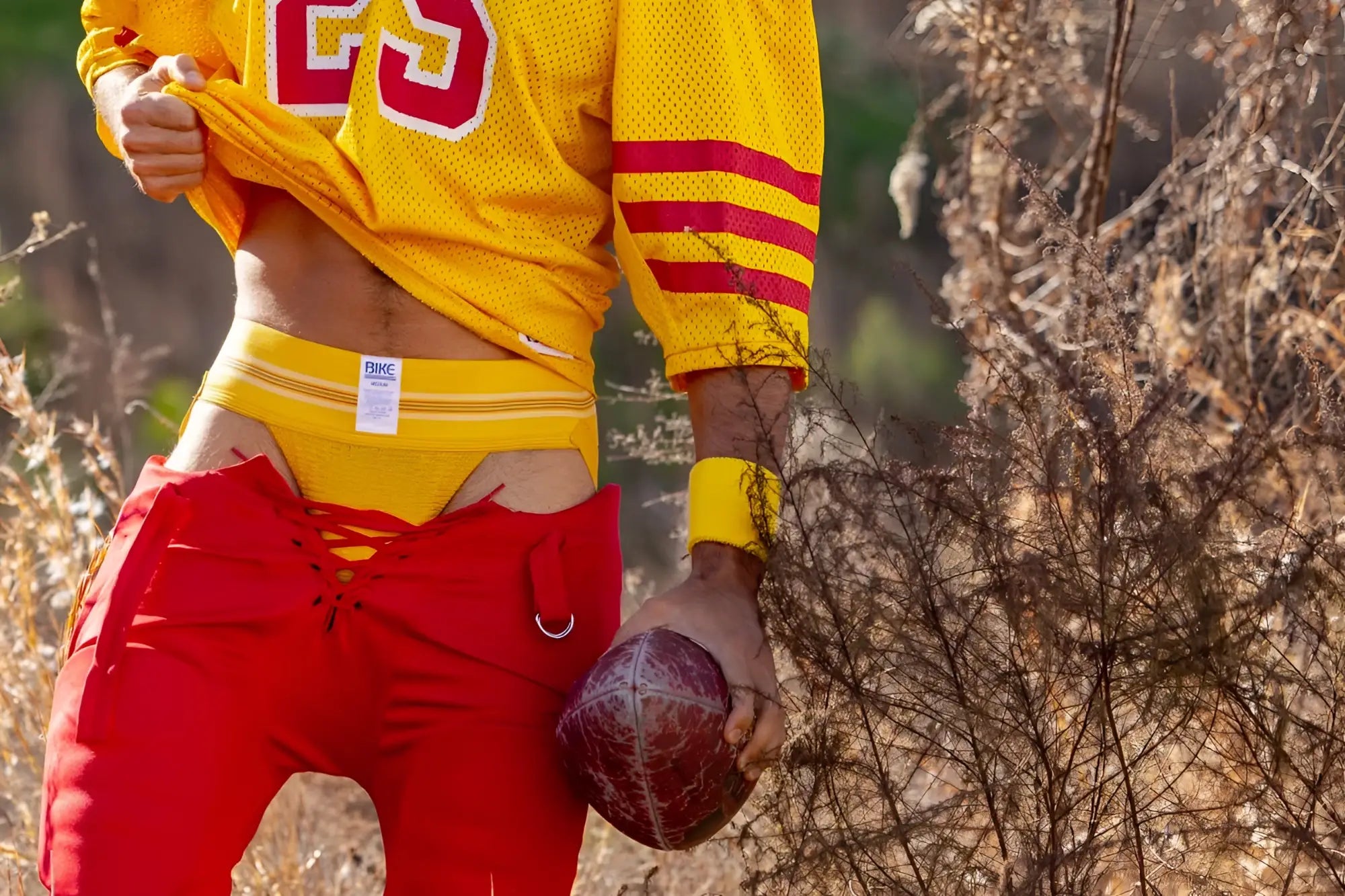 Yellow mesh football jersey with red and white number 23 on the chest from bike athletic in yellow color