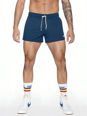 Navy blue bike track short with white drawstrings and a small logo on the lower right leg for athletic wear
