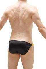 Black swim trunks with shiny satin fabric and a small yellow chain detail on the side from bikini chains satin black