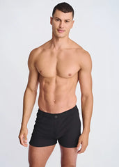 Black seersucker swim shorts with mesh lining featuring a sleek minimalist design and single button waistband closure