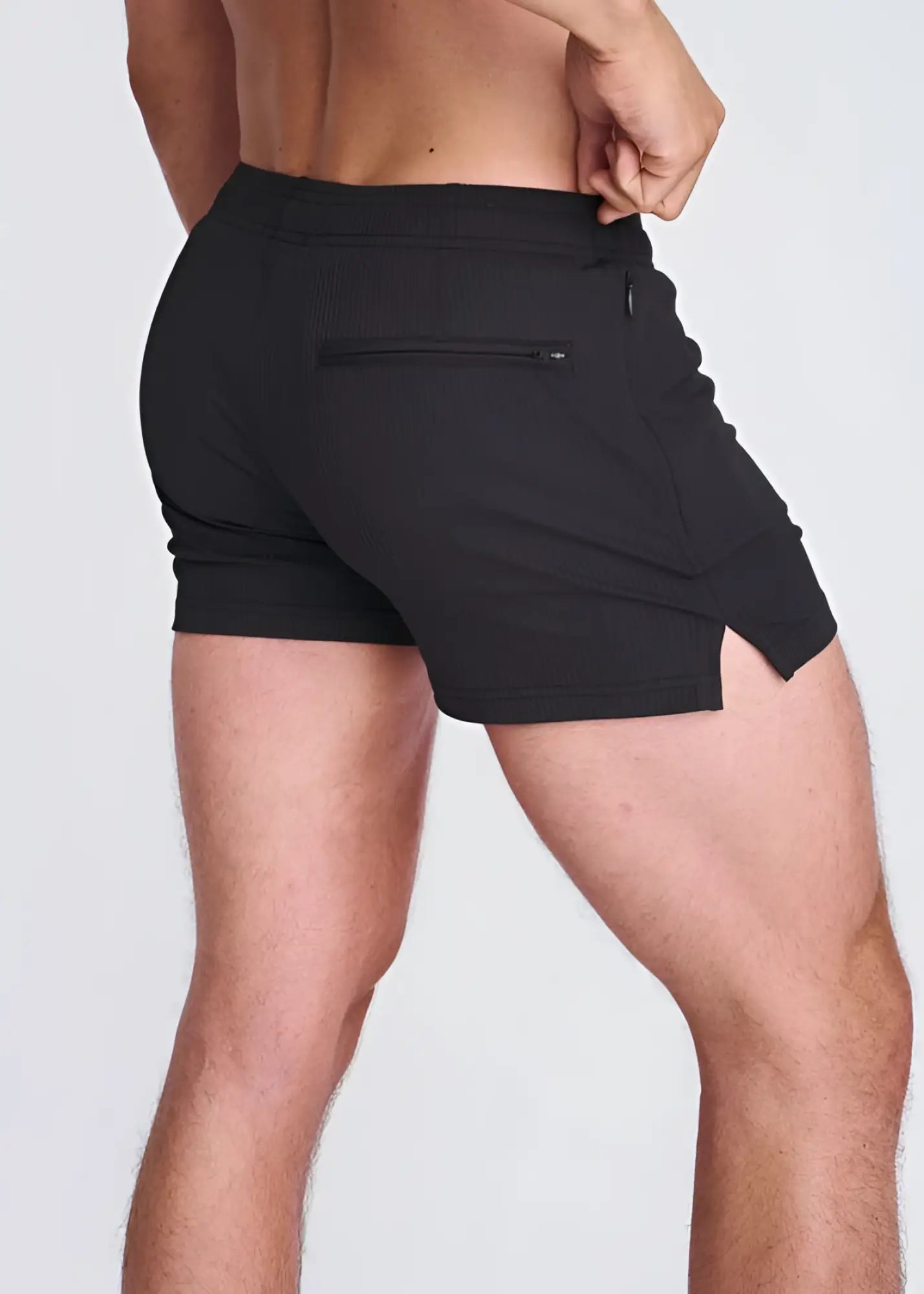 Black seersucker swim shorts with mesh lining showing zippered back pocket and side slit on the back side
