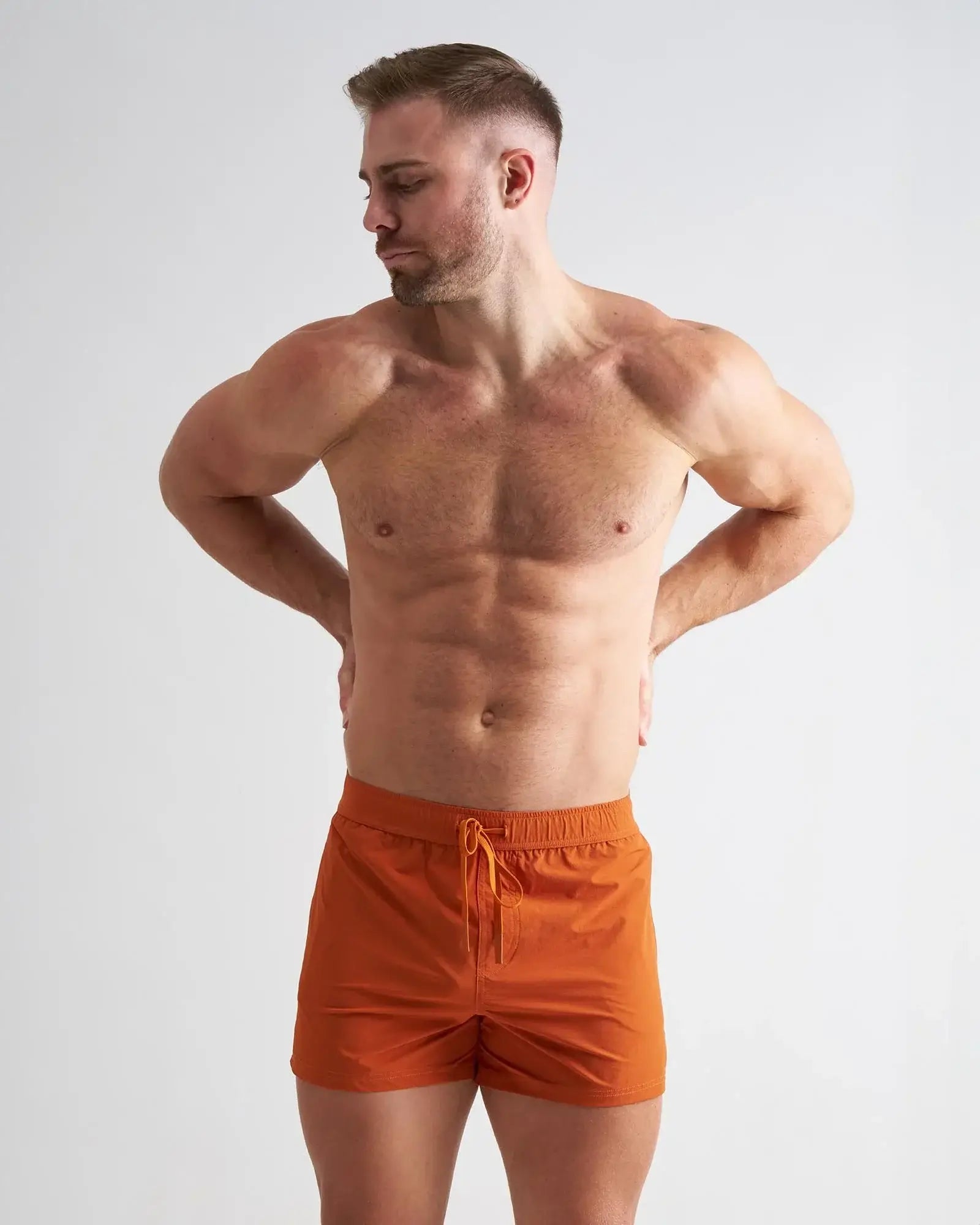 Orange bolt 3 inch athletic shorts with drawstring waistband made of breathable fabric for active use