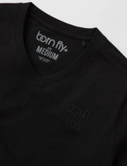 Black cotton born fly v-neck t-shirt with subtle embroidered logo on chest and tagline inside collar