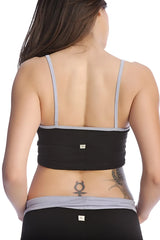 Black and gray bra top showing the elasticized back panel for comfortable support in a sports setting