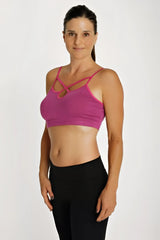 A vibrant magenta bra top plum with crisscross shoulder straps and a seamless supportive sports bra design