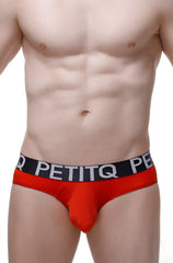 Red petitq men’s briefs with a black waistband featuring white lettering from brief bulan plum red collection