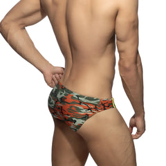 Bright camo swim brief featuring orange and green camouflage pattern with yellow trim designed for swimming use