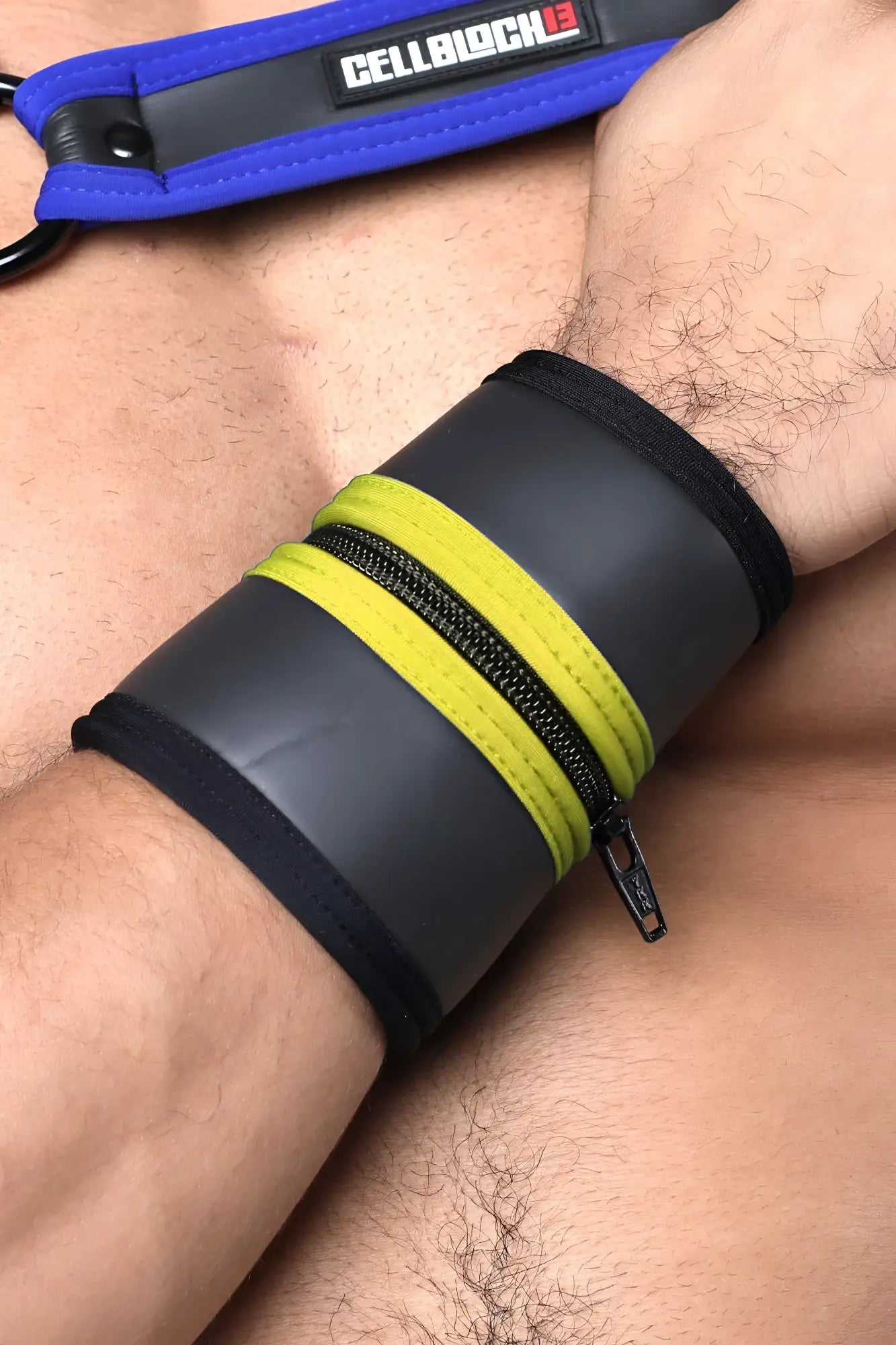 Black and neon yellow buckle up cuff wrist cuff with blue cellblock branded strap and zipper closure