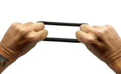 Black rubber BUFU ring being stretched between two hands showing its elasticity and flexibility
