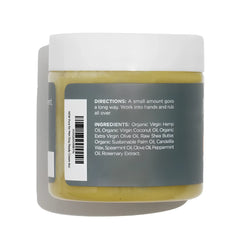 A clear glass jar with a white lid contains yellowish-green organic bum balm hand cream with label details