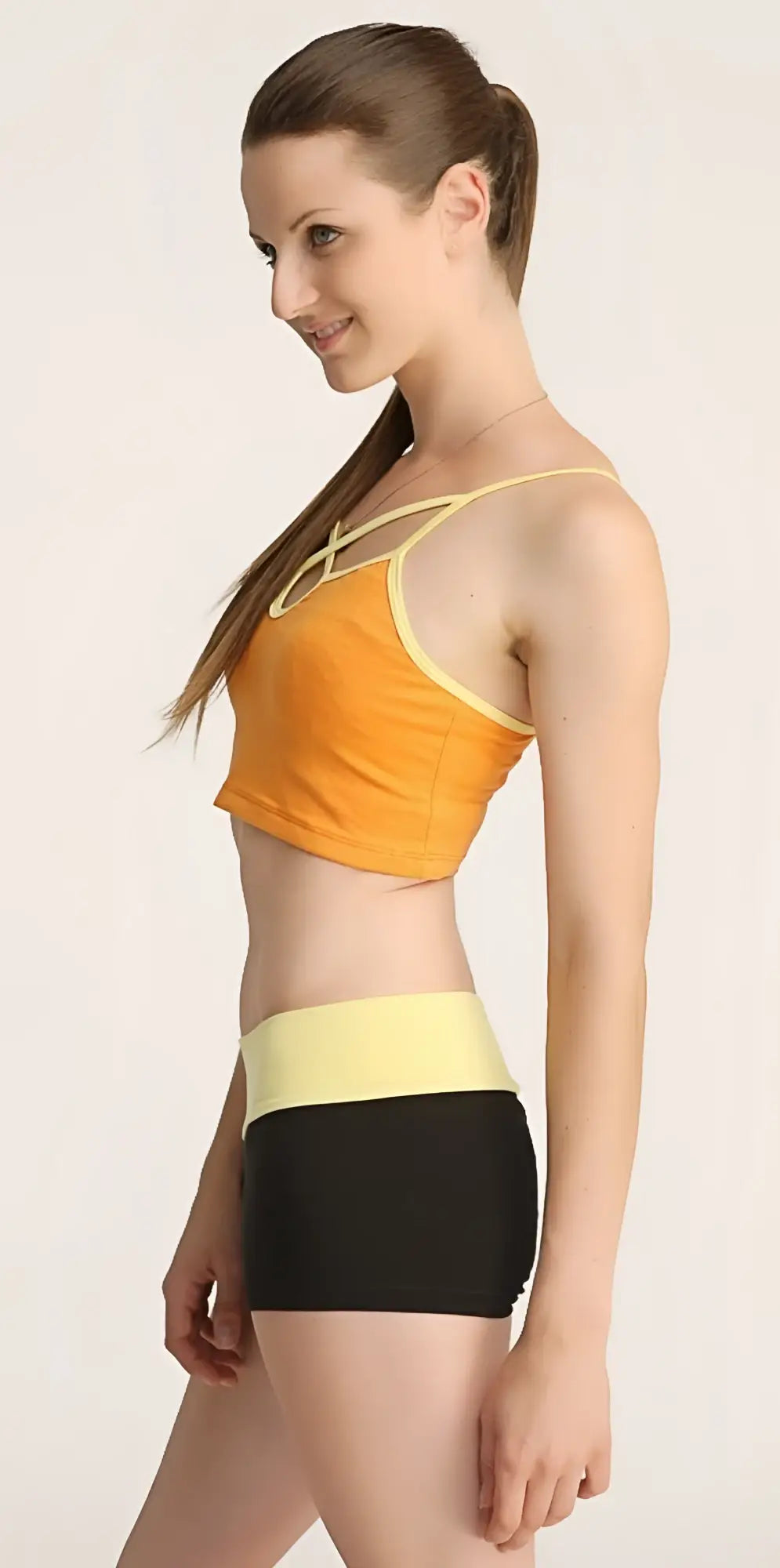 Orange and yellow cropped top with thin straps and matching high-waisted black shorts set bumble short