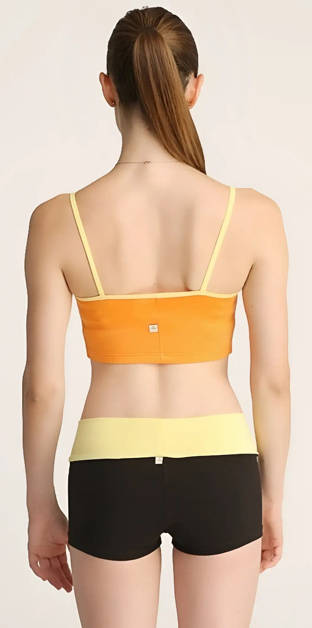 Orange and yellow strap sports bra paired with black bumble short perfect for activewear and workouts