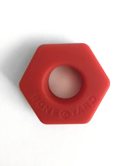 Red hexagonal silicone ring bust a nut with bone yard embossed on its surface