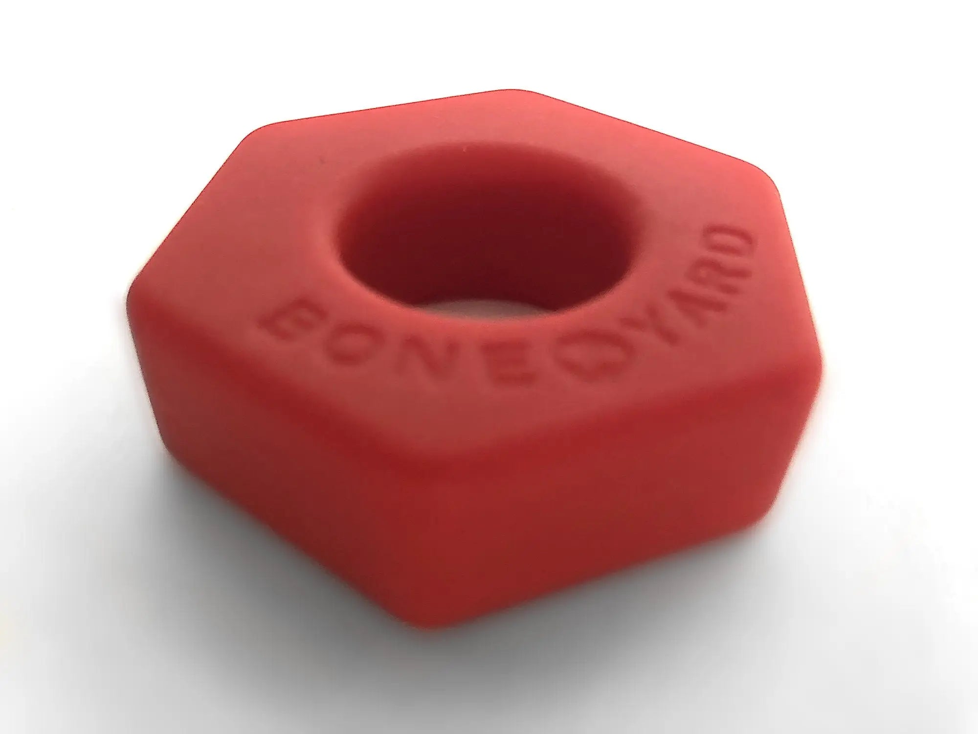 Red hexagonal silicone nut shaped boneyard bust a nut tool for gripping and loosening fasteners