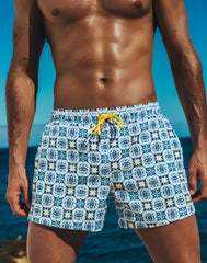 Byron swim short mykonos print featuring blue and white patterned fabric with yellow drawstring for beachwear