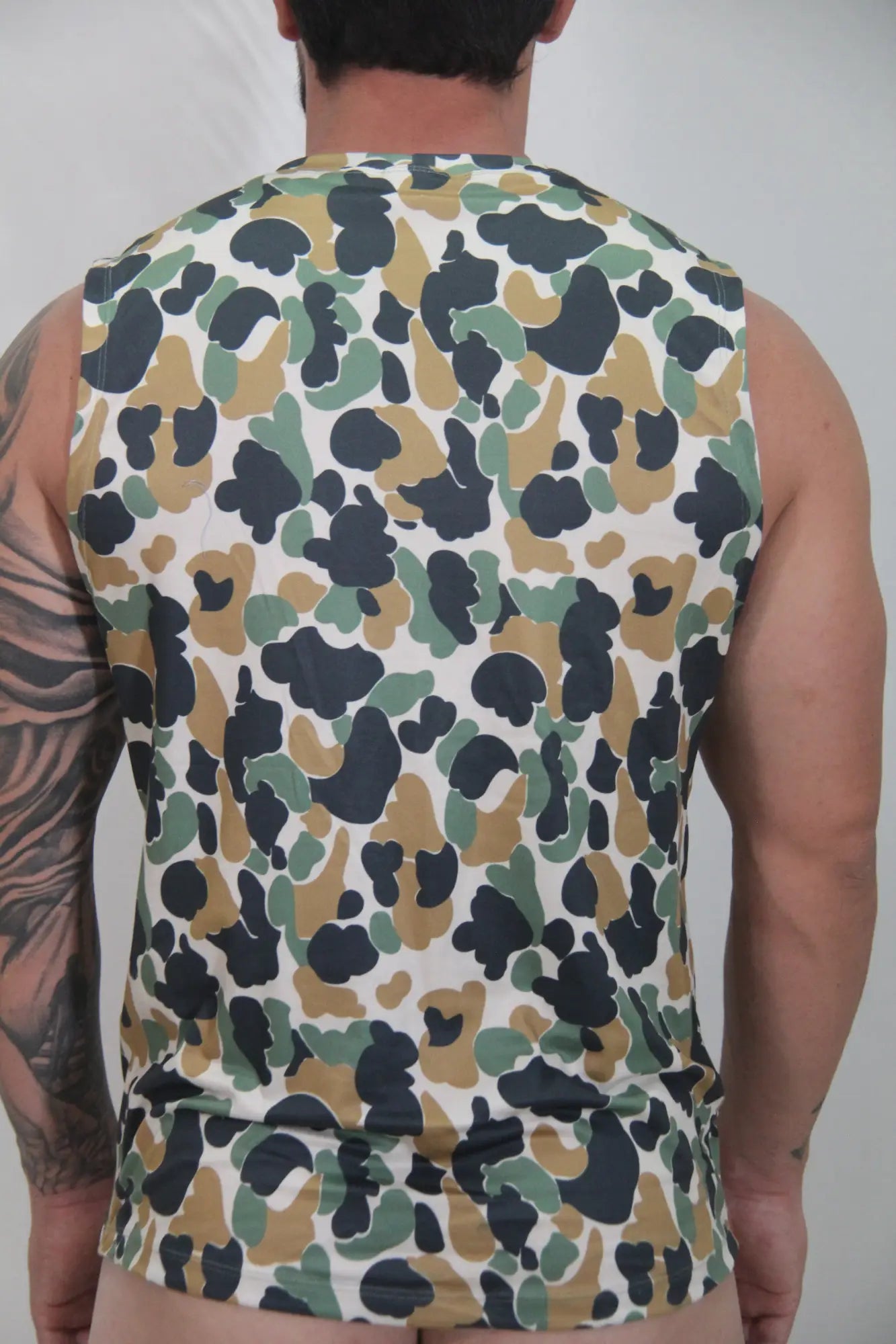 Camouflage open arm tank sleeveless top with olive green tan and black splotches on white base in soft fabric