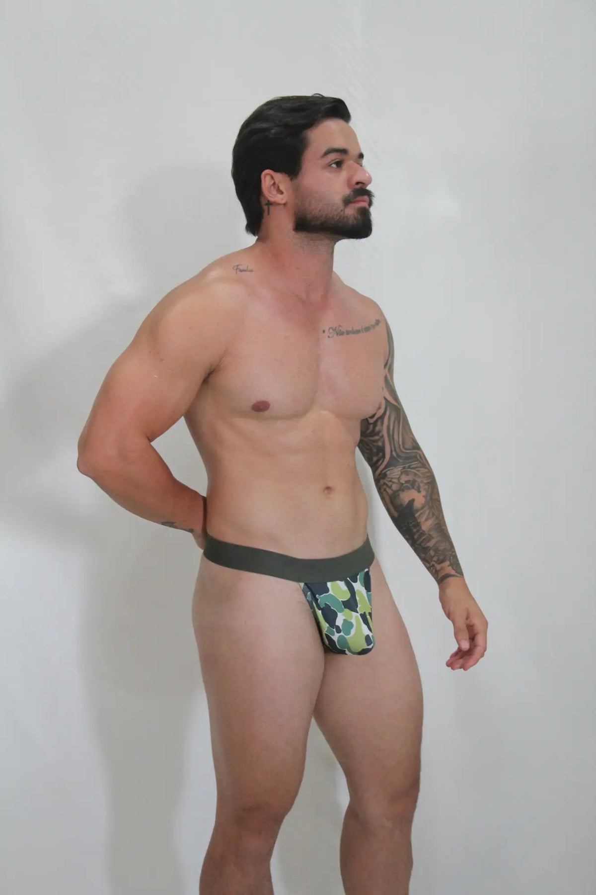 Green and white camouflage thong with a solid dark green waistband showing the front side design