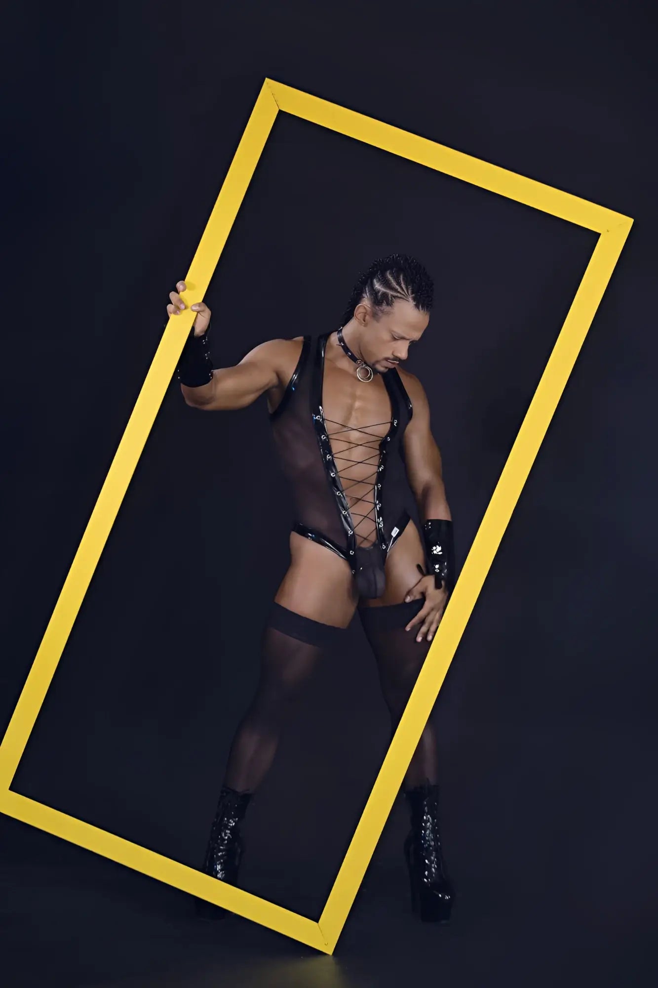 A bold yellow rectangular frame highlighting the black candyMan 99774 gladiator bodysuit front view