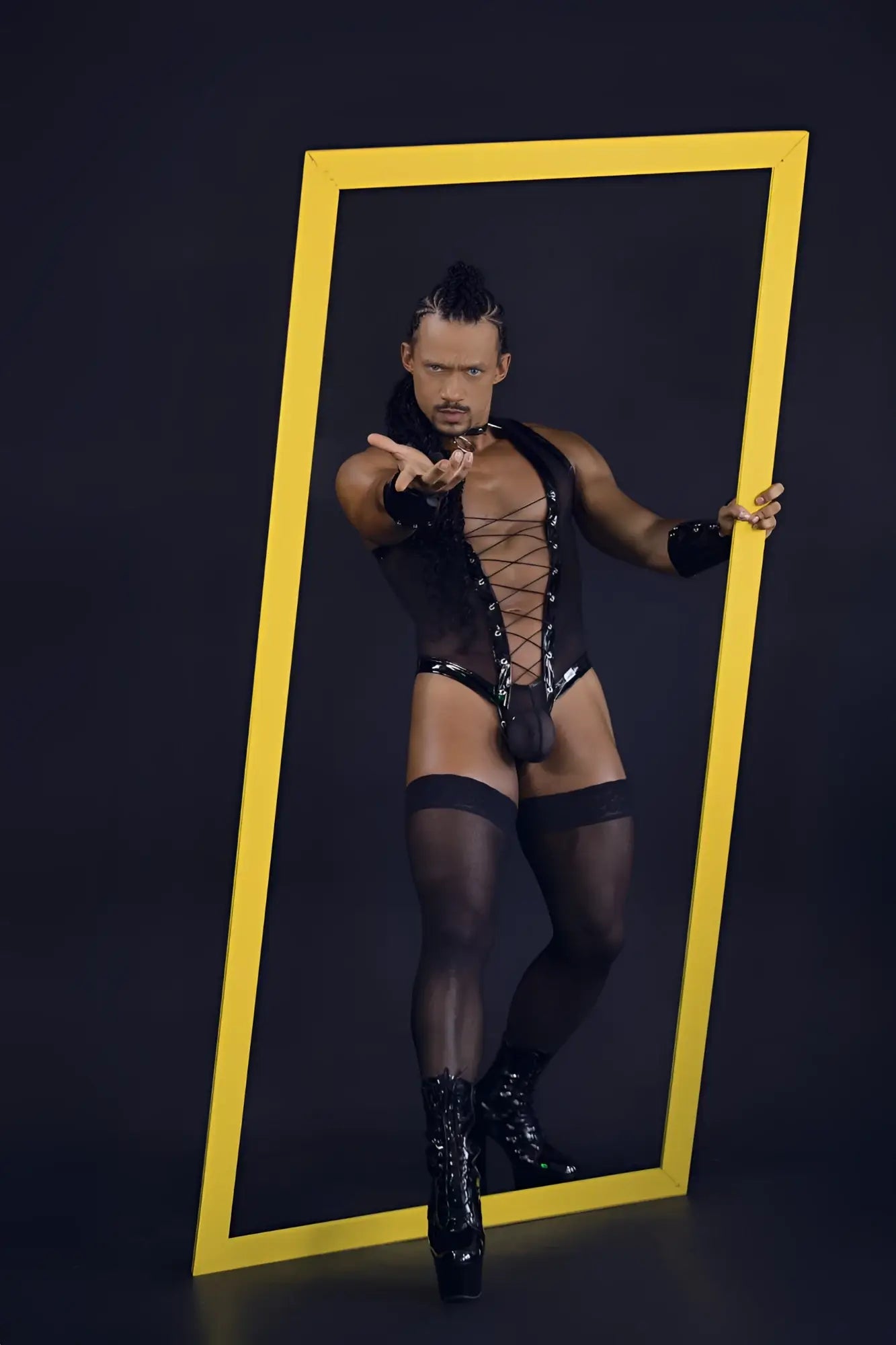 Black candyMan 99774 gladiator lace-up bodysuit with sheer mesh panels and high-heeled boots