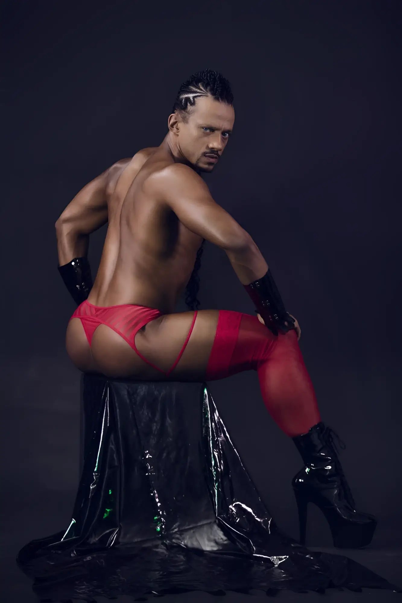 Red latex mesh garter thongs with matching arm cuffs and black high-heeled boots from candyman 99792
